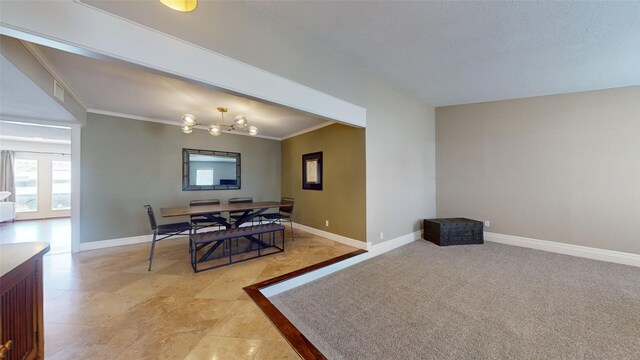 dining area featuring crown molding and a notable chandelier