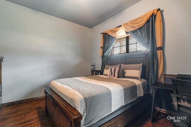 bedroom with dark wood-type flooring