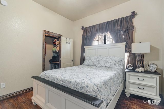 bedroom with dark hardwood / wood-style flooring