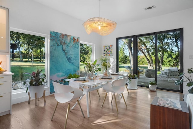 dining space with visible vents and light wood-style floors