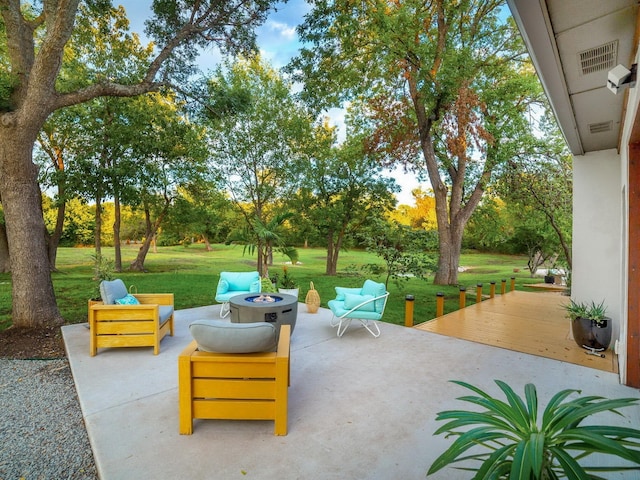 view of patio / terrace with an outdoor fire pit and visible vents