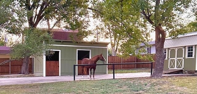 exterior space with fence and an outdoor structure