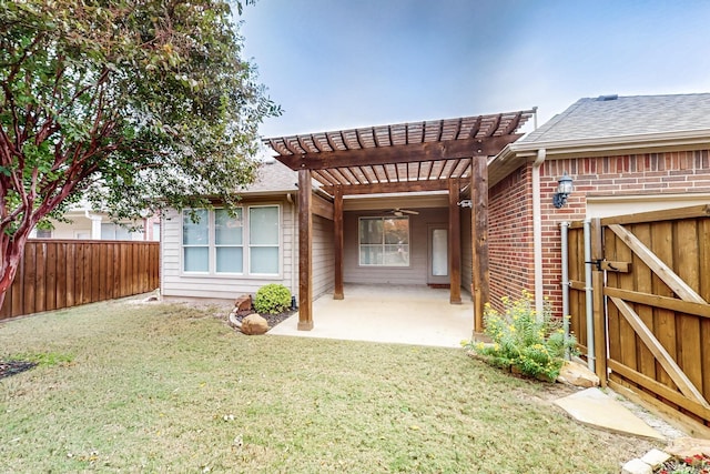 rear view of property featuring a patio, a lawn, ceiling fan, and a pergola