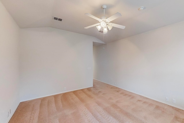 carpeted empty room with ceiling fan and vaulted ceiling