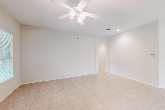 empty room with light tile patterned flooring and ceiling fan