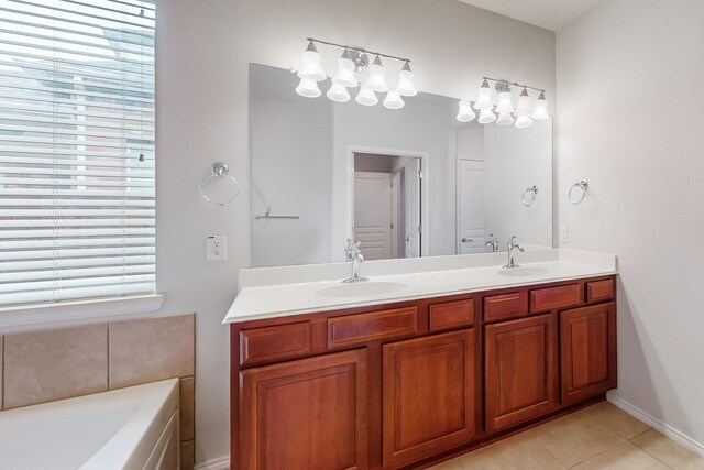 bathroom featuring vanity, tile patterned flooring, and a tub