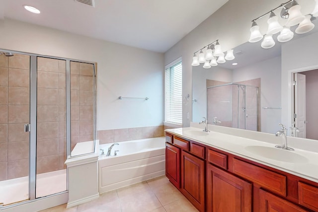 bathroom with tile patterned floors, shower with separate bathtub, and vanity