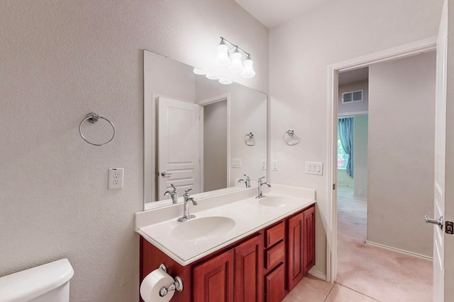 bathroom with vanity, tile patterned flooring, and toilet