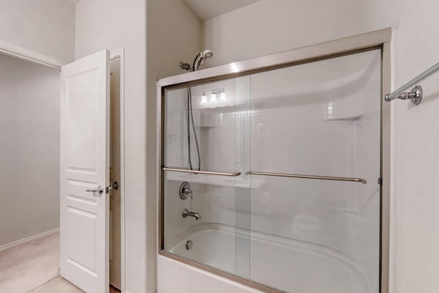 bathroom with shower / bath combination with glass door