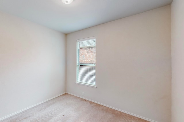 empty room featuring a healthy amount of sunlight and light colored carpet