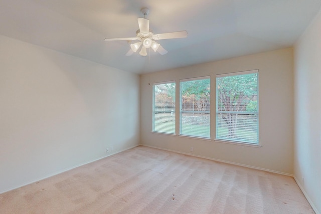 unfurnished room with ceiling fan and light carpet