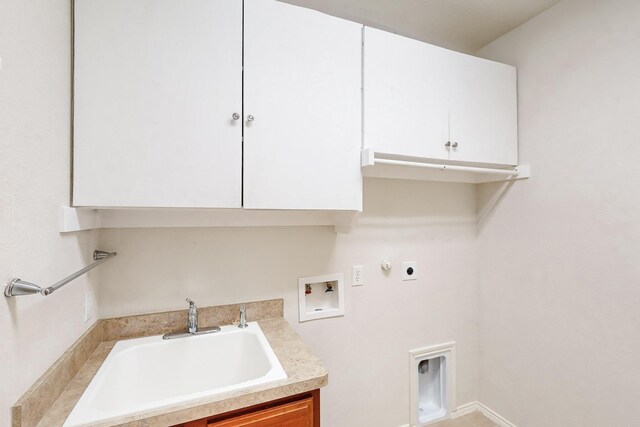 washroom featuring gas dryer hookup, sink, cabinets, hookup for a washing machine, and hookup for an electric dryer