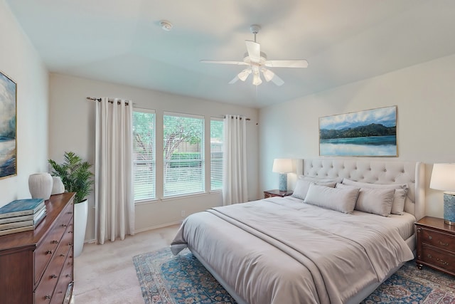 bedroom with ceiling fan and light carpet