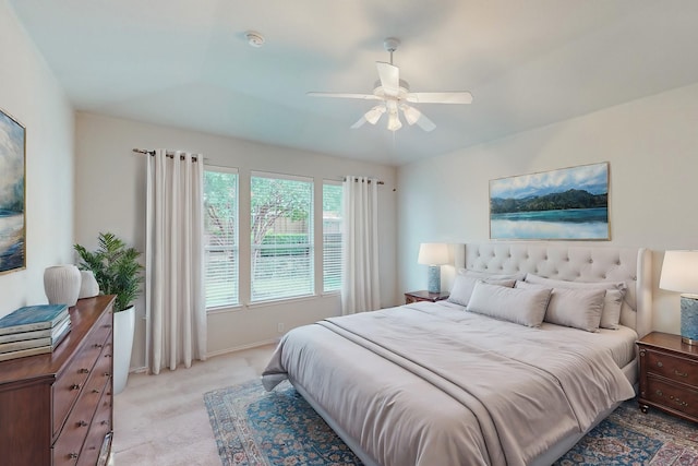 bedroom with light carpet, baseboards, and ceiling fan