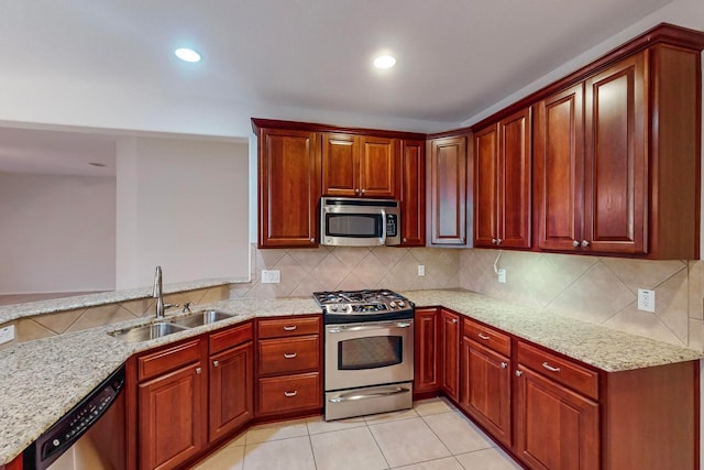 kitchen featuring sink, light tile patterned floors, stainless steel appliances, and light stone countertops