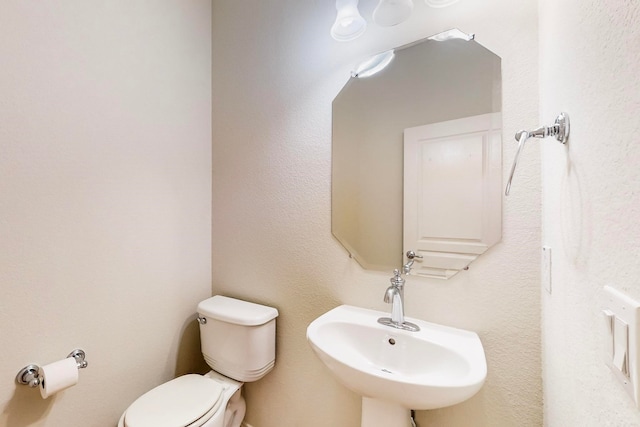 bathroom with sink and toilet