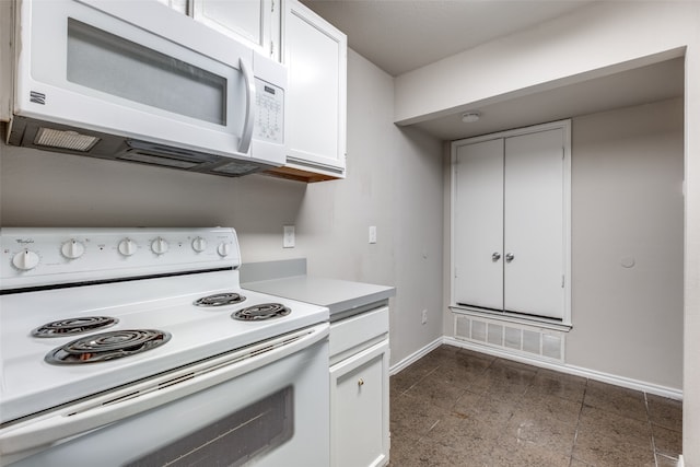 kitchen with white cabinetry and white appliances