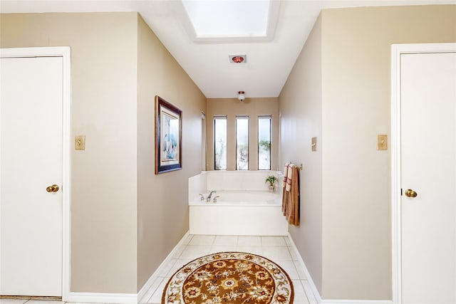 bathroom with tile patterned flooring and a washtub