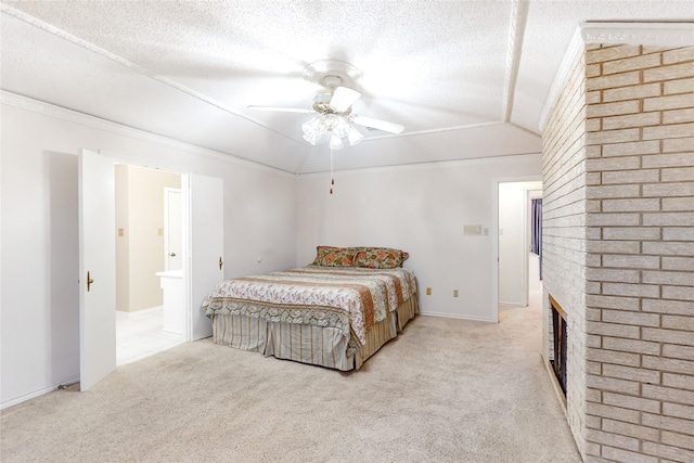 carpeted bedroom featuring lofted ceiling, ornamental molding, a fireplace, and a textured ceiling