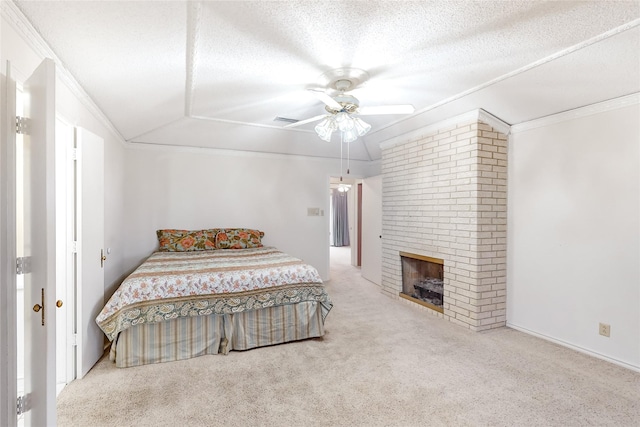 carpeted bedroom with crown molding, a fireplace, a textured ceiling, and ceiling fan