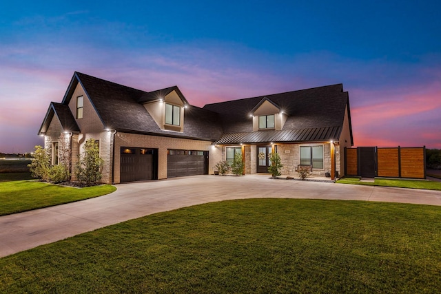 view of front of home featuring a garage and a yard