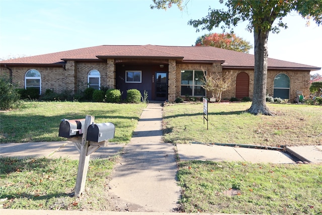 ranch-style house with a front lawn