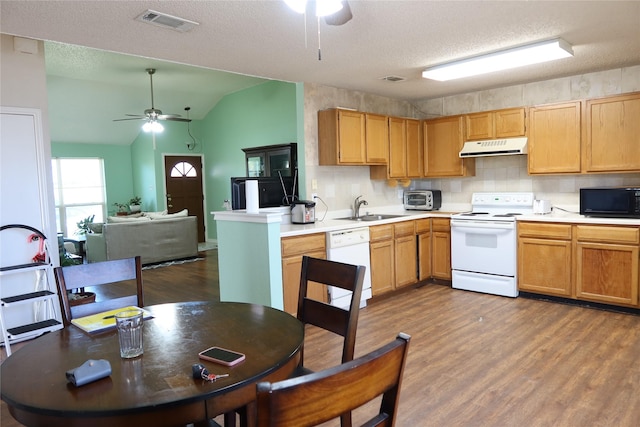 kitchen featuring white appliances, a textured ceiling, dark wood-type flooring, and vaulted ceiling