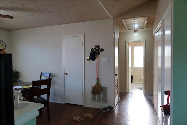 interior space with dark hardwood / wood-style flooring and a textured ceiling