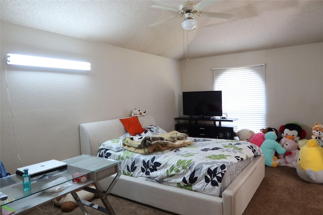 carpeted bedroom featuring ceiling fan and a textured ceiling