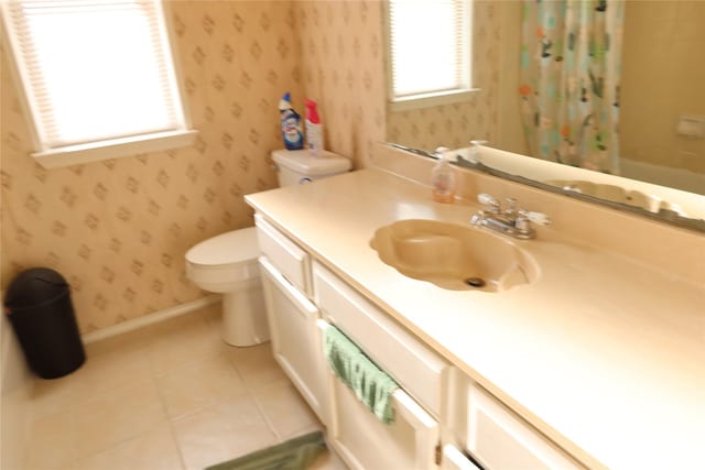 full bathroom with vanity, shower / tub combo with curtain, tile patterned floors, and toilet