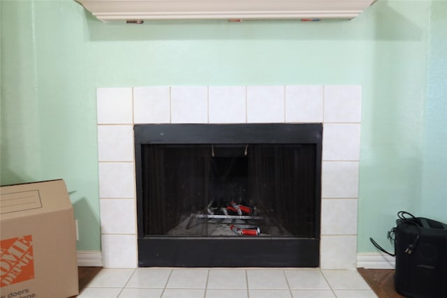 interior details featuring a tile fireplace