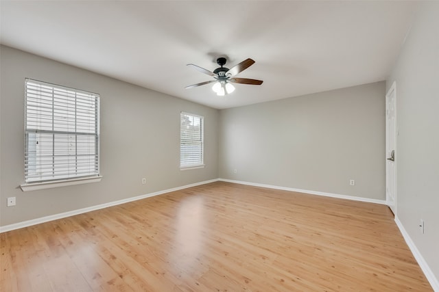 empty room with light hardwood / wood-style floors, plenty of natural light, and ceiling fan