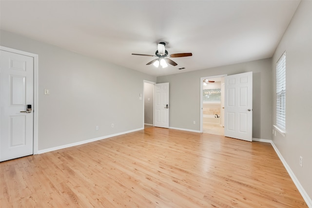 unfurnished bedroom featuring ceiling fan, light wood-type flooring, and ensuite bath