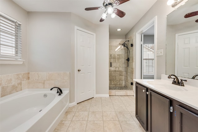 bathroom with independent shower and bath, vanity, and a healthy amount of sunlight