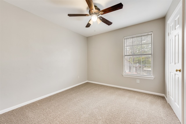 carpeted spare room with ceiling fan