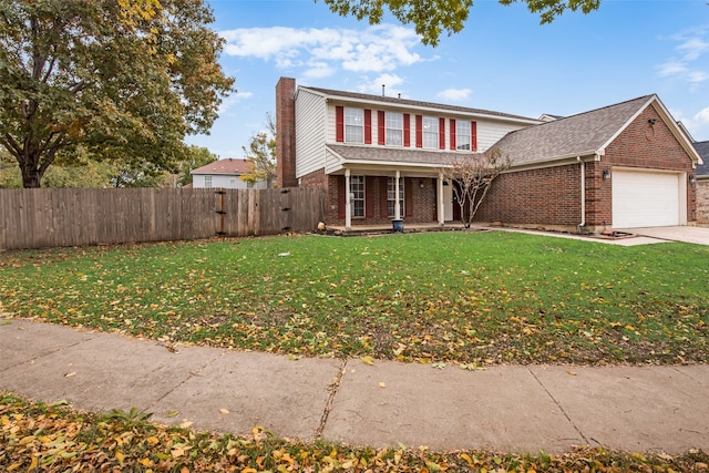 view of front property with a front yard and a garage