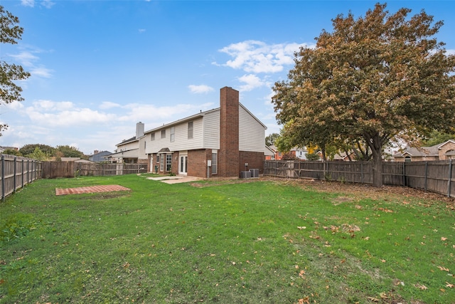 view of yard with a patio and central air condition unit