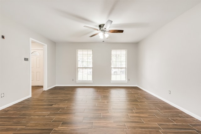 spare room featuring ceiling fan and dark wood-type flooring