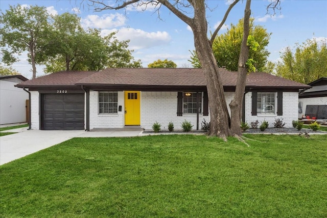 ranch-style home featuring a garage and a front lawn