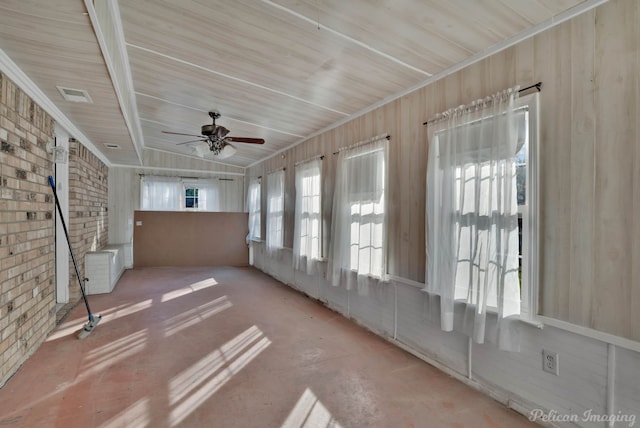 unfurnished sunroom with ceiling fan