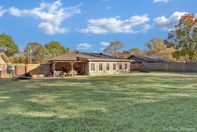 rear view of property featuring a yard