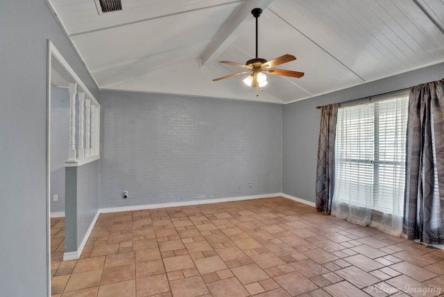 spare room featuring lofted ceiling with beams, brick wall, and ceiling fan