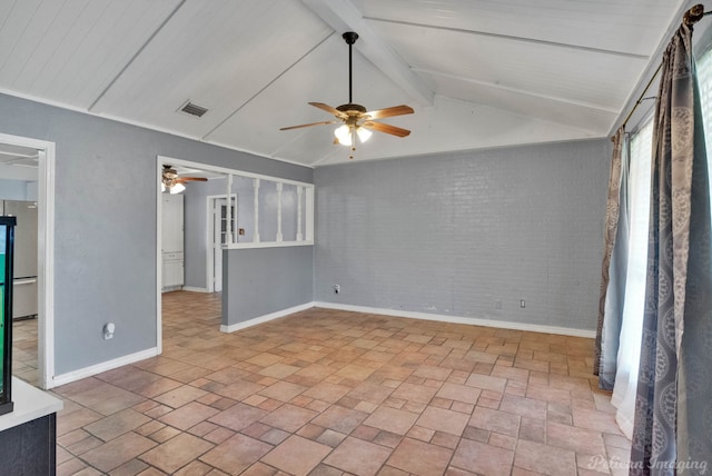 unfurnished living room with vaulted ceiling with beams, ceiling fan, and brick wall