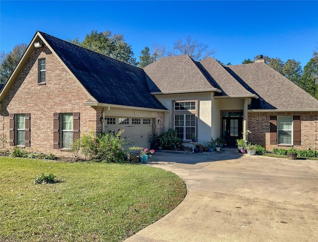 view of front of property featuring a garage and a front lawn