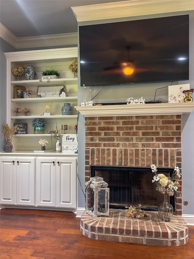 interior details featuring hardwood / wood-style flooring, crown molding, and a fireplace