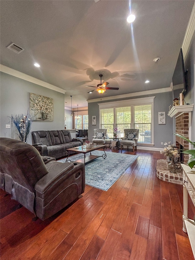 living room featuring a fireplace, ornamental molding, plenty of natural light, and dark wood-type flooring