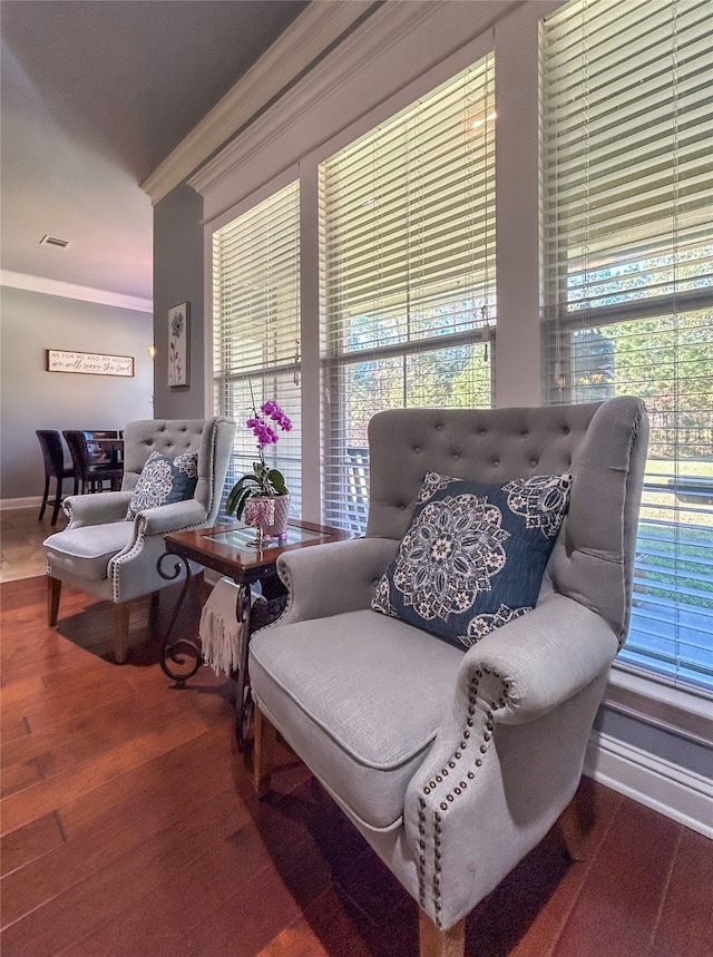 living room with hardwood / wood-style flooring, crown molding, and a wealth of natural light