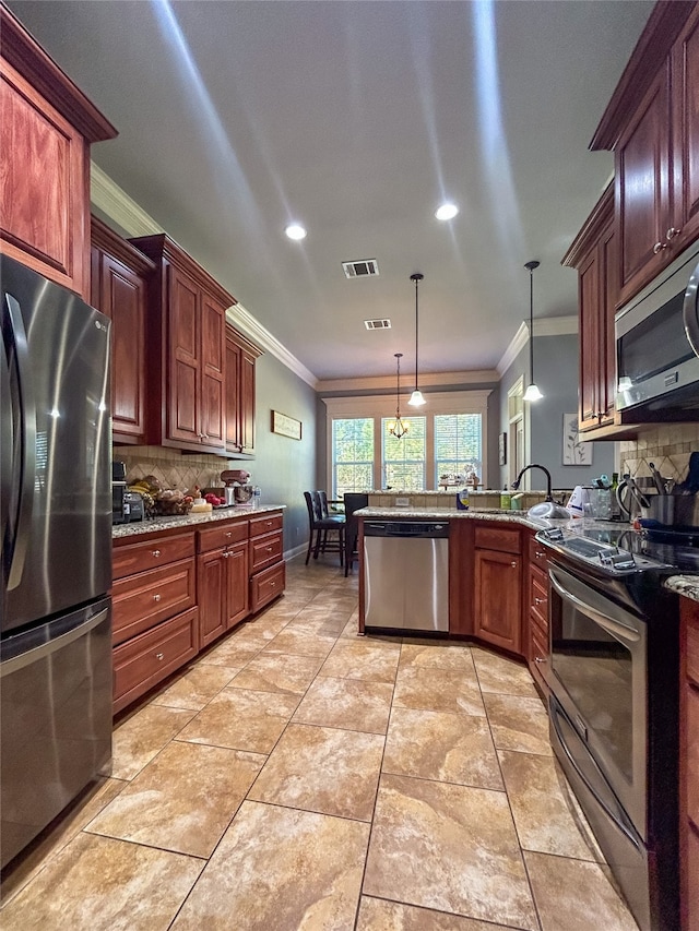 kitchen with pendant lighting, ornamental molding, stainless steel appliances, and tasteful backsplash