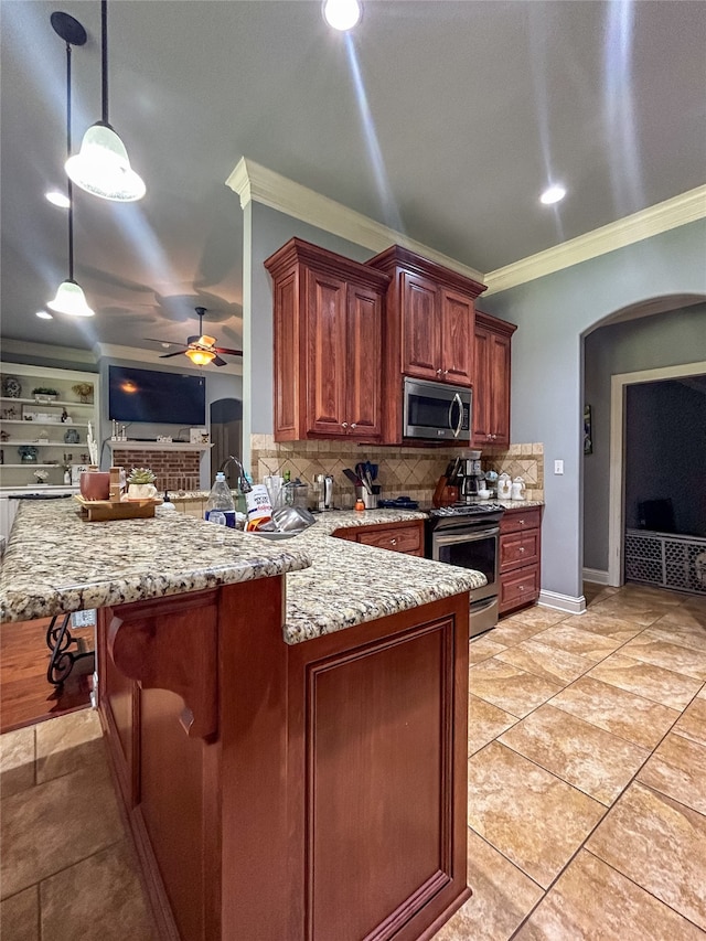 kitchen with kitchen peninsula, ornamental molding, stainless steel appliances, ceiling fan, and pendant lighting