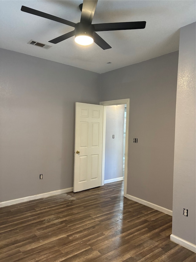 unfurnished room featuring ceiling fan and dark hardwood / wood-style flooring